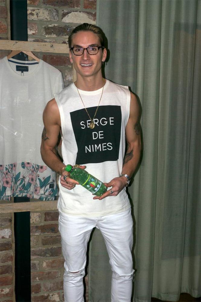 Proudlock at his Serge DeNimes Spring/Summer 15 collection launch holding a bottle of AquaVita