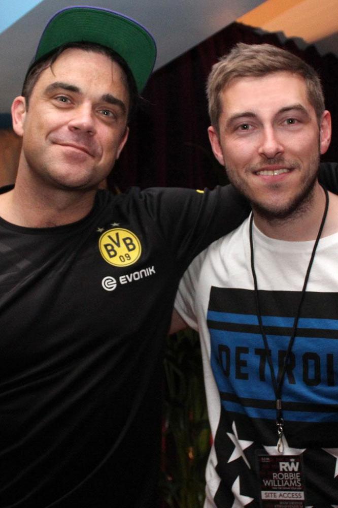 Robbie Williams (L) with radio host Alex James