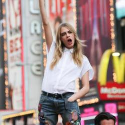 Cara Delevingne posing in her DKNY ad campaign