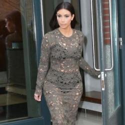 Kim Kardashian flaunts her figure in a lace dress