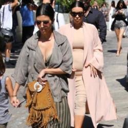 Kim Kardashian West (right) and Kourtney Kardashian