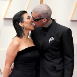 Kourtney Kardashian and Travis Barker have a reason for kissing with their tongues on the red carpet