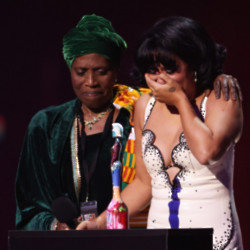 RAYE broke down in tears as she brought her grandmother up on stage with her at the 2024 BRIT Awards with Mastercard