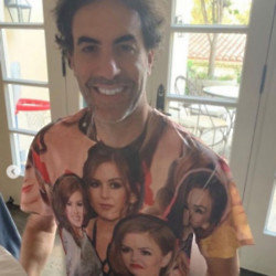 Sacha Baron-Cohen posing in his unique T-shirt to celebrate 20 years with Isla Fisher