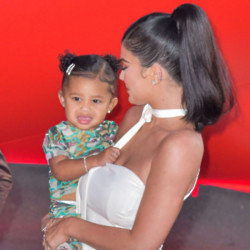 Kylie Jenner shared a previously unseen snap of her daughter kissing her pregnant belly