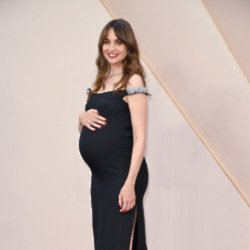 Tuppence Middleton placing a hand on her baby bump at the Downton Abbey: A New Era premiere