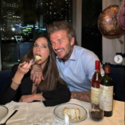 Victoria Beckham tucks into some cake for her birthday with husband David