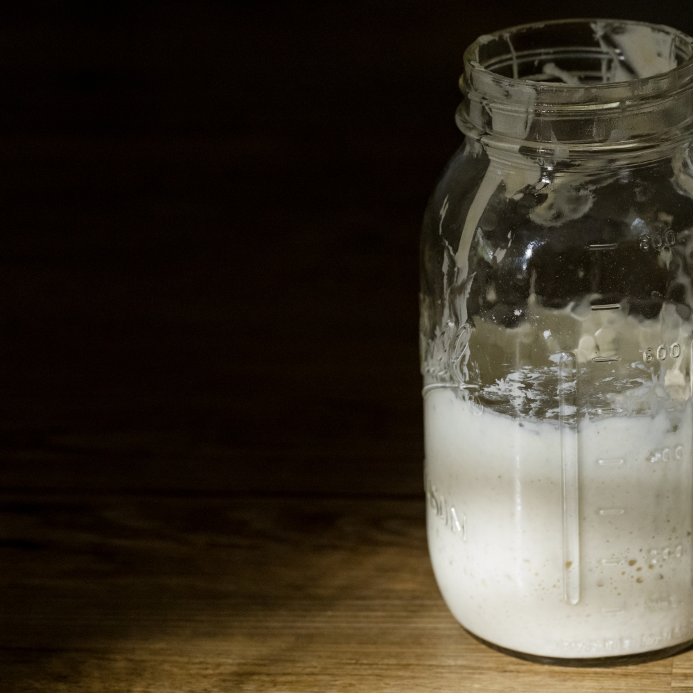 Sourdough starter in large glass jar on the wooden table (iStock/PA)