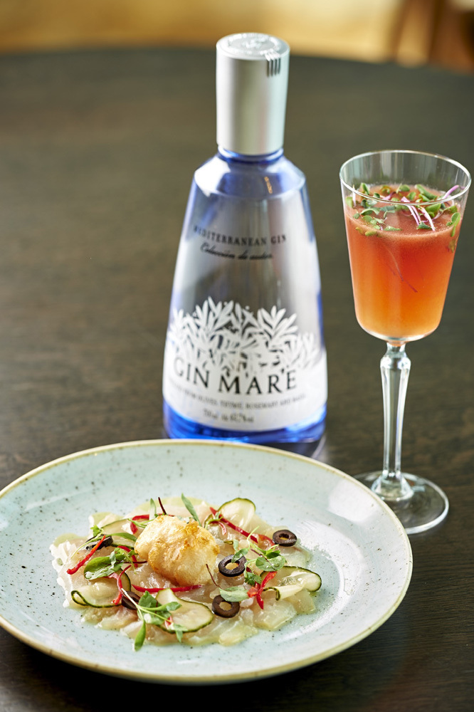 Gin Mare Cured Sea Bass with Pickled Cucumber, Black Olives, Chilli & a Scallop Beignet in Tonic Batter