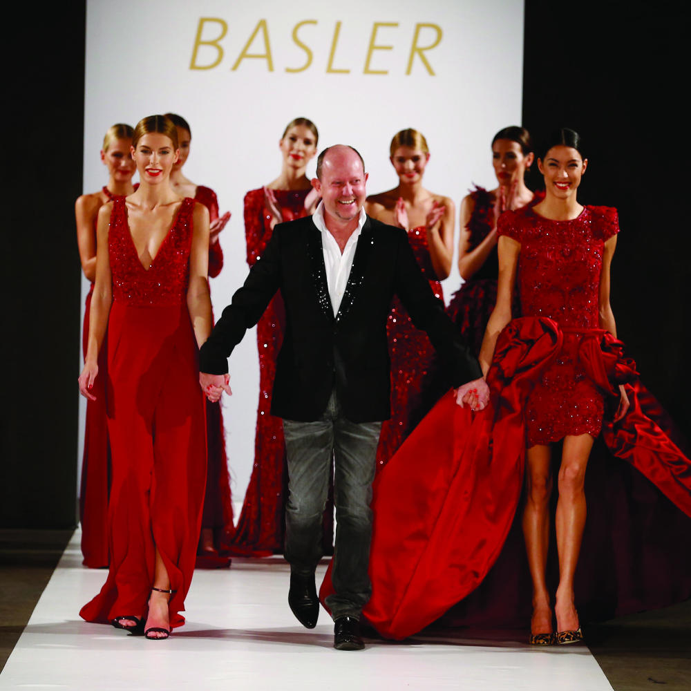 The designer takes his bow with the runway models