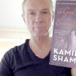Gary Kemp holding a copy of A God in Every Stone