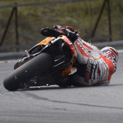 Marc Marquez falls off his motorcycle and sparks fly everywhere as the motorbike grind along the ground.