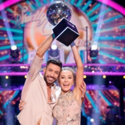 Giovanni and Rose raise the Strictly Glitterball / Picture Credit: BBC/Guy Levy